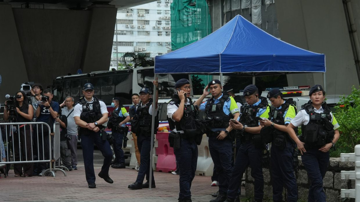 Hong Kong woman arrested for seditious T-shirt outside court as democracy advocates face conviction